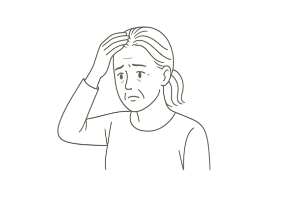 患者が鏡を見ながら、生え際の後退を不安そうに気にしている様子
